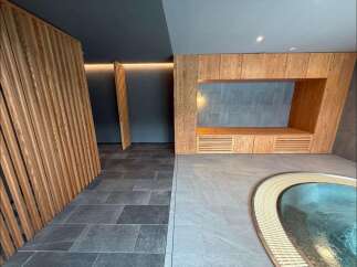 Experience tranquility in this modern spa oasis, featuring a soothing pool and elegant wooden accents.