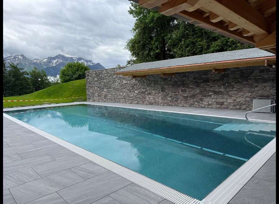 Experience luxury outdoor living with this stunning infinity pool, perfectly integrated into a breathtaking mountain landscape.
