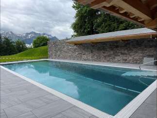 Experience luxury outdoor living with this stunning infinity pool, perfectly integrated into a breathtaking mountain landscape.