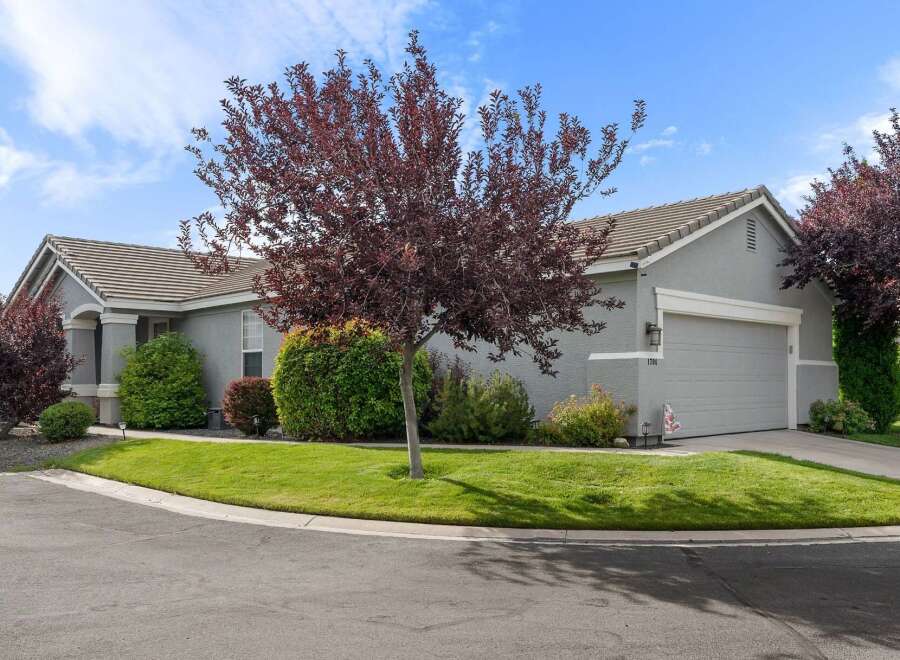 Discover this charming single-family home featuring a well-maintained lawn and mature trees, perfect for enjoying the outdoors.