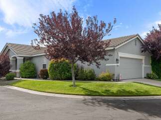 Discover this charming single-family home featuring a well-maintained lawn and mature trees, perfect for enjoying the outdoors.
