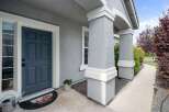 Welcome guests to your home with this charming front entrance featuring a classic blue door and a decorative doormat.