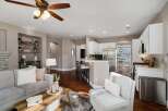 Experience open-concept living in this beautifully appointed home, featuring a spacious living area flowing seamlessly into a modern kitchen with ample cabinet space and a convenient breakfast bar.