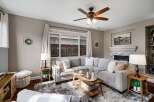 Cozy living room featuring a plush sectional sofa centered around a rustic coffee table, perfect for family gatherings.