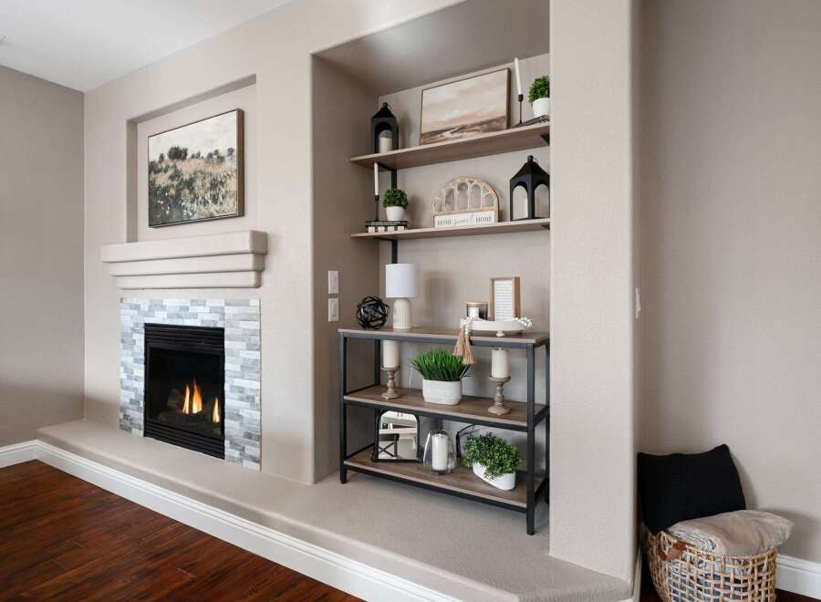 Cozy living room featuring a modern gas fireplace with a stacked stone surround and a sleek mantel.