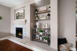 Cozy living room featuring a modern gas fireplace with a stacked stone surround and a sleek mantel.