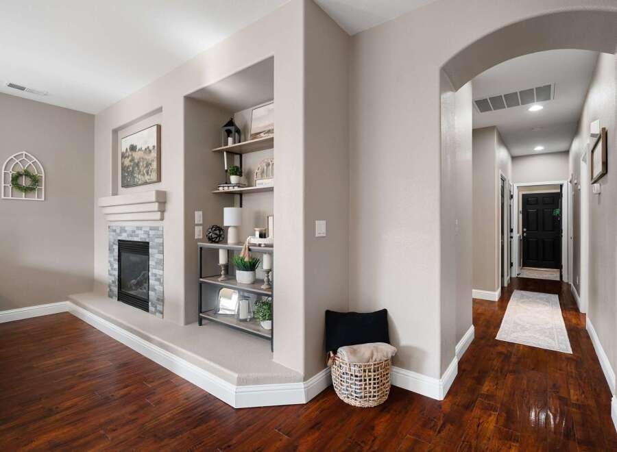 Step into this inviting living space featuring a modern fireplace with a stone surround and a sleek mantel.