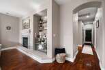 Step into this inviting living space featuring a modern fireplace with a stone surround and a sleek mantel.