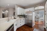 Discover this beautifully updated kitchen featuring sleek stainless steel appliances, including a French door refrigerator and a built-in microwave.