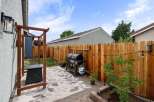 Enjoy outdoor living in this charming backyard featuring a spacious patio area perfect for entertaining.