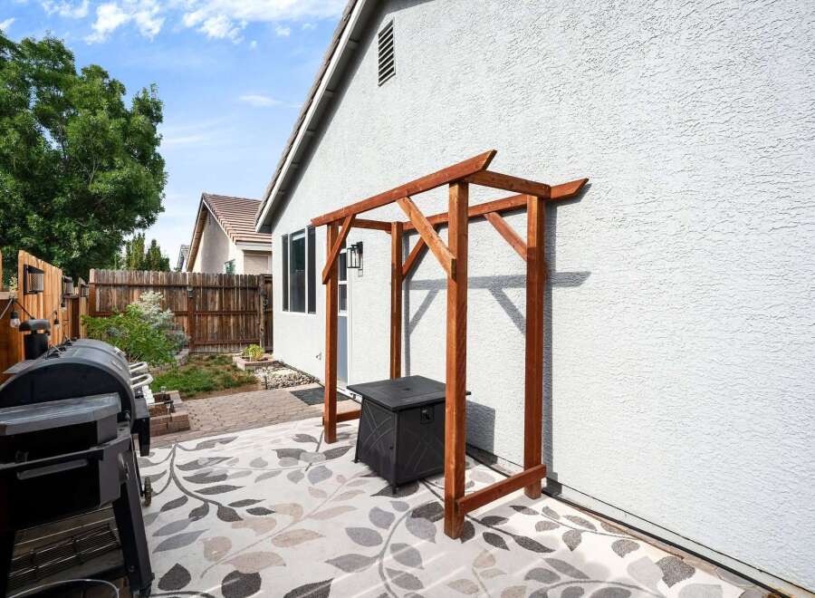 Enjoy outdoor living with this charming backyard featuring a spacious patio area perfect for entertaining.