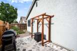 Enjoy outdoor living with this charming backyard featuring a spacious patio area perfect for entertaining.