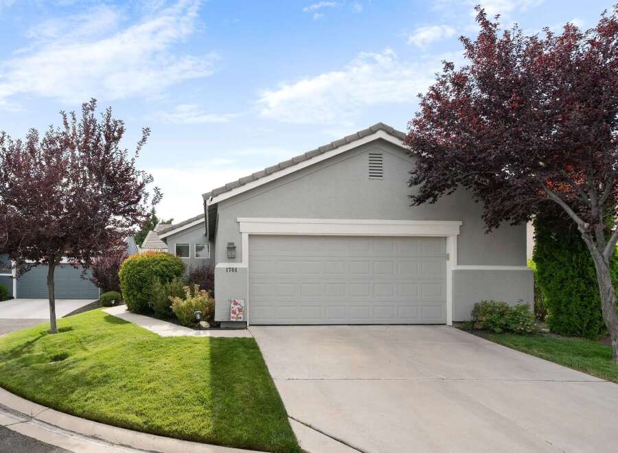 Discover this charming single-family home featuring a well-maintained exterior with lush green landscaping and mature trees.