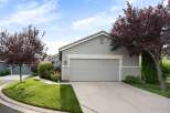 Discover this charming single-family home featuring a well-maintained exterior with lush green landscaping and mature trees.