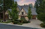 Discover this stunning Tudor-style home nestled amongst mature trees, offering a picturesque setting.