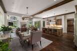 Experience luxurious open-concept living in this stunning home, featuring a grand fireplace and a spacious dining area perfect for entertaining.