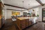 Experience luxury living in this expansive open-concept home, featuring a gourmet kitchen with a large island and farmhouse sink, perfect for entertaining.