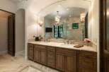 Indulge in luxury with this stunning master bathroom featuring a spacious double vanity with rich wooden cabinetry and elegant marble countertops.