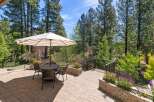 Enjoy outdoor living on this beautiful paved patio, complete with a dining set and umbrella, perfect for al fresco meals.