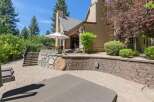 Enjoy outdoor living at its finest with this expansive patio featuring a luxurious hot tub and comfortable lounge chairs.