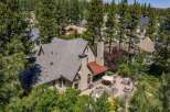 Nestled amidst towering pine trees, this stunning property offers a luxurious retreat with an expansive outdoor living space.