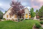 This stunning home features a spacious backyard with a lush green lawn, perfect for outdoor activities and entertaining.