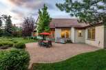 Enjoy outdoor living with this spacious patio featuring a dining set and a built-in grill, perfect for entertaining.