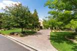 Welcome to this stunning property featuring a beautifully paved driveway leading to an elegant home.