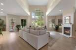 Experience luxury living in this stunning great room, featuring a soaring vaulted ceiling and expansive windows that flood the space with natural light.