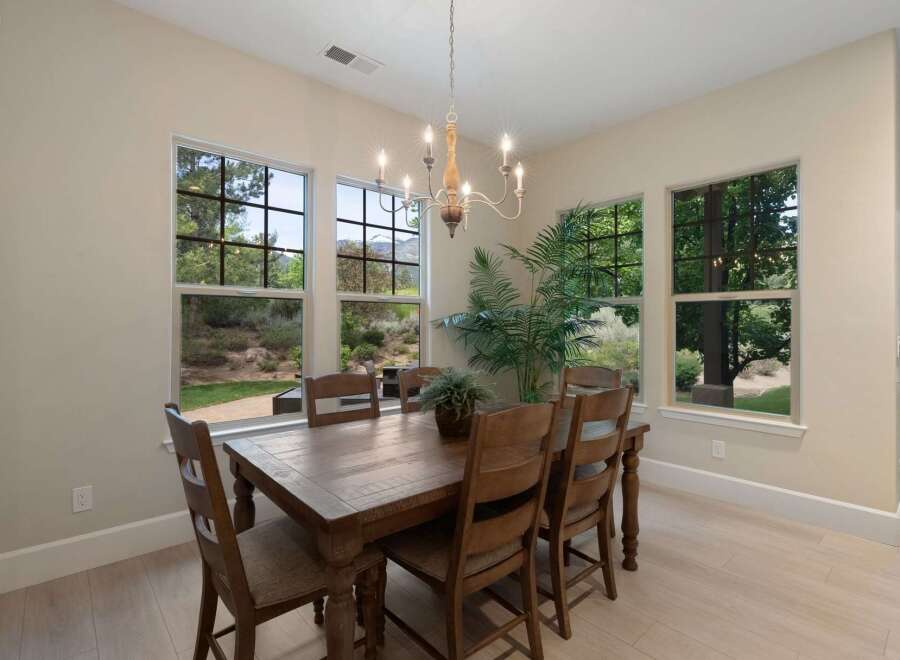Experience breathtaking natural beauty from this elegant dining room, featuring large windows that showcase stunning mountain and forest views.
