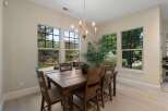 Experience breathtaking natural beauty from this elegant dining room, featuring large windows that showcase stunning mountain and forest views.