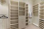 This spacious walk-in closet features ample shelving and storage solutions, perfect for organizing your wardrobe.