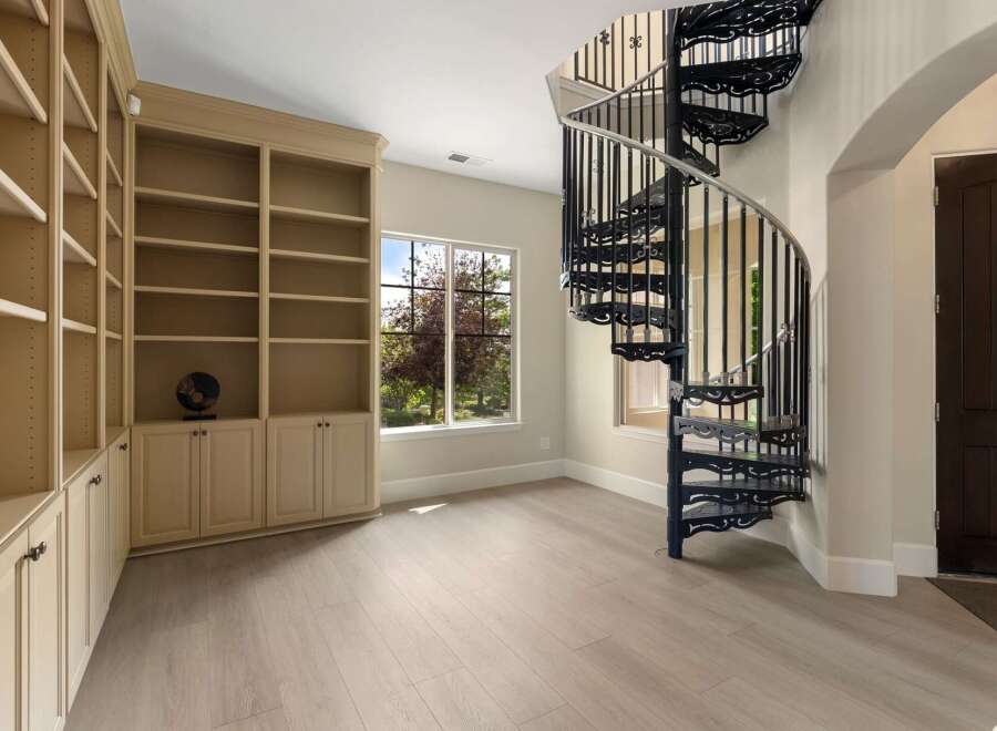 Discover this unique home featuring a stunning black spiral staircase as a focal point, perfect for adding architectural interest.
