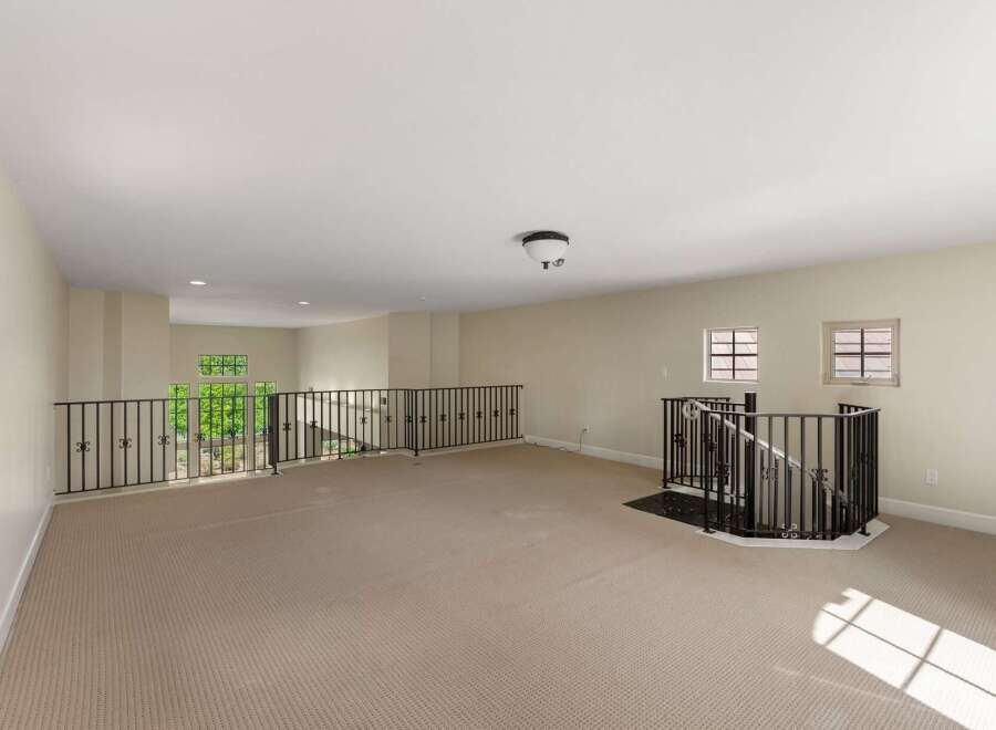 This spacious loft area offers a versatile open floor plan, perfect for creating your dream living space or entertainment hub.