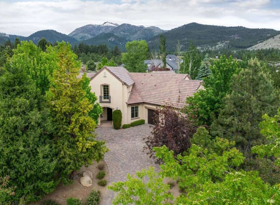 Nestled amidst lush greenery and majestic mountains, this stunning residence offers a serene escape.