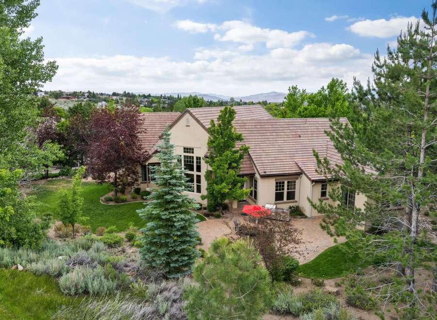 Experience luxury living in this stunning estate, featuring a sprawling backyard with a paved patio perfect for outdoor entertaining.