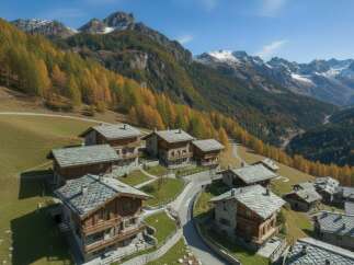 Discover luxurious mountain living in this stunning alpine village featuring charming wooden chalets with stone accents and slate roofs.