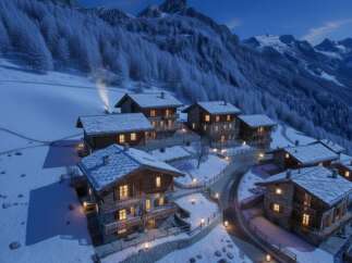 Experience the ultimate winter retreat in this charming alpine village, featuring cozy chalets nestled amidst snow-covered mountains.