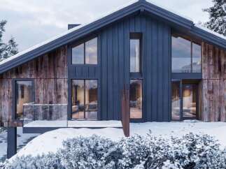 Experience modern mountain living in this stunning architectural gem, featuring a striking blend of dark metal siding and rustic wood accents.