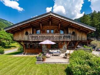 Experience the charm of this stunning wooden chalet nestled in a picturesque mountain setting.