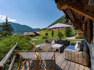 Enjoy breathtaking mountain views from this charming wooden deck, perfect for relaxing or entertaining.