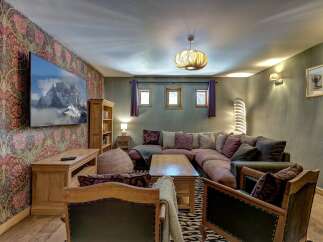 Experience ultimate comfort in this inviting living room, featuring a spacious sectional sofa perfect for gatherings and a large flat-screen TV for entertainment.
