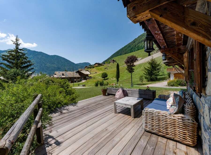 Enjoy breathtaking mountain views from this charming wooden deck, perfect for relaxing or entertaining.