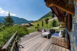 Enjoy breathtaking mountain views from this charming wooden deck, perfect for relaxing or entertaining.
