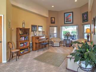 Step into this inviting living space, featuring a beautiful upright piano perfect for musical evenings.