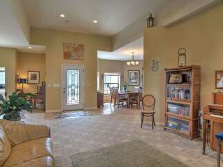 Step into this inviting living space featuring a spacious open floor plan that seamlessly connects the living, dining, and entryway areas.