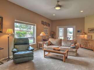 Step into this inviting living room, featuring a plush sofa and a comfortable recliner perfect for relaxation.
