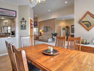 This spacious dining area flows seamlessly into a comfortable living room, perfect for entertaining guests.