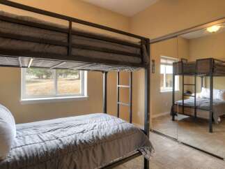 This bedroom features a space-saving bunk bed setup, perfect for maximizing sleeping capacity.