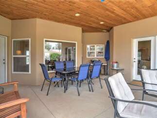 Enjoy outdoor living on this spacious covered patio, perfect for entertaining or relaxing.
